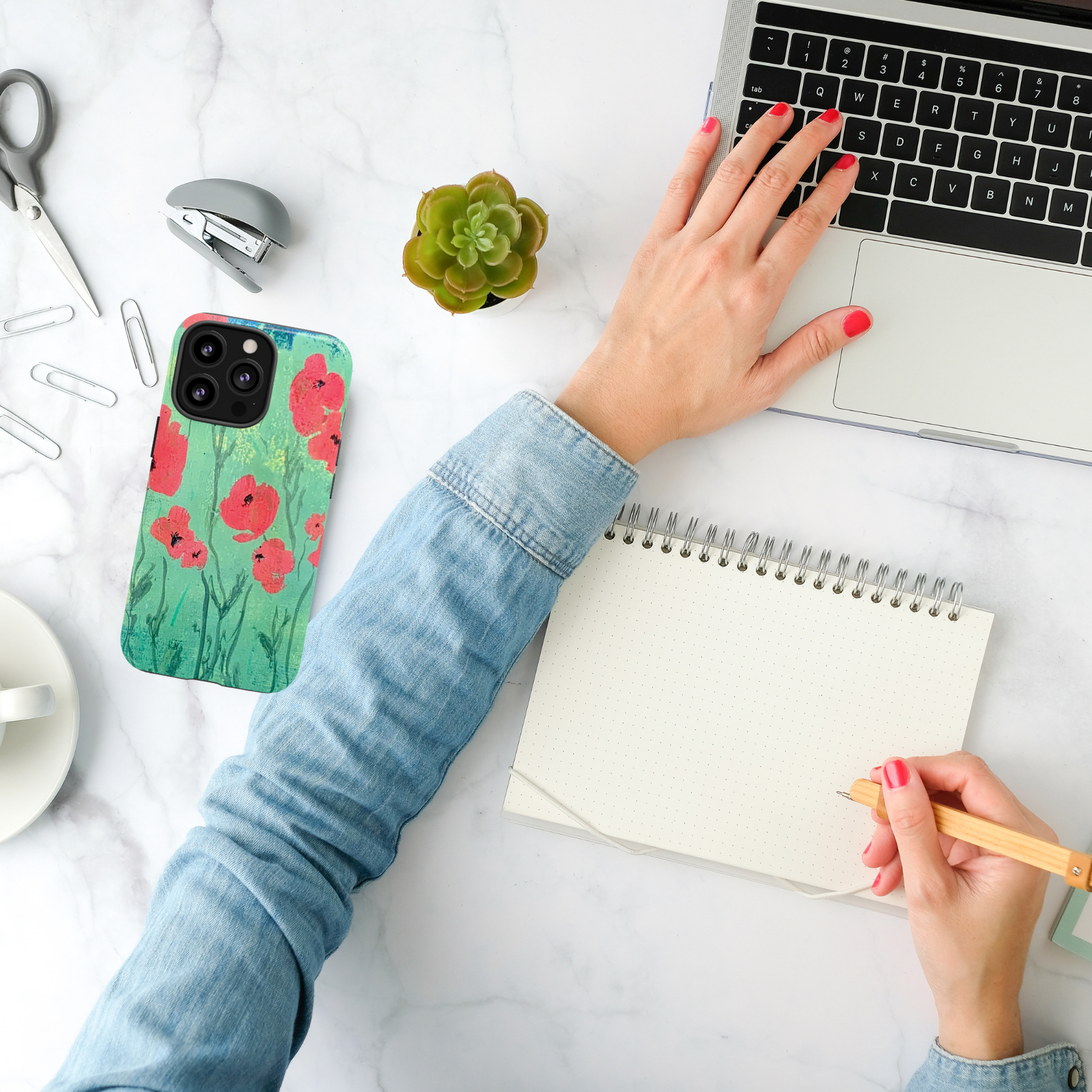 hand painted flowers on phone case on woman creative desk