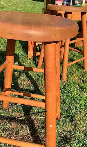 Wooden stool on a grassy outdoor surface